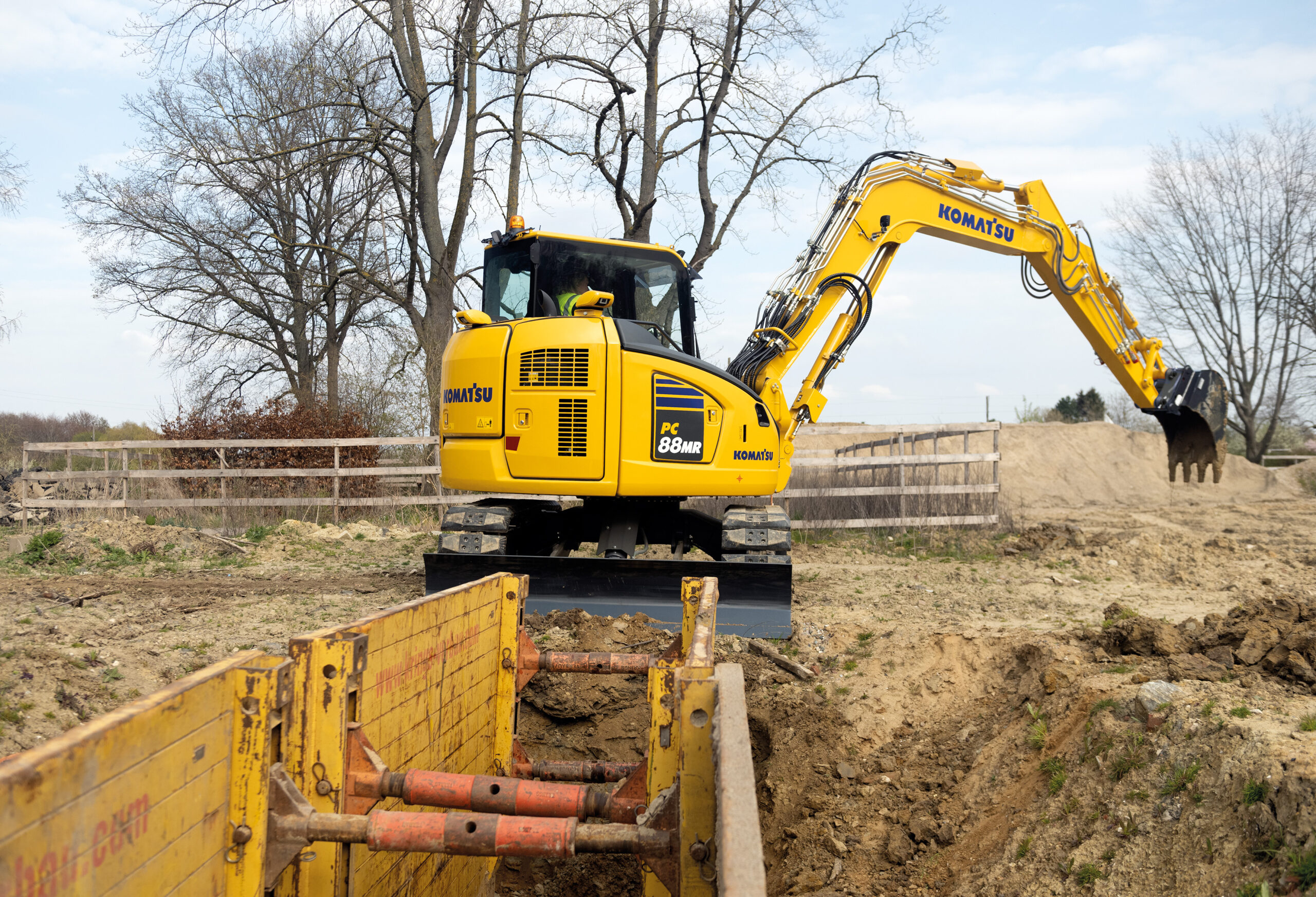Komatsu PC88MR-11 gräver utomhus på en gård